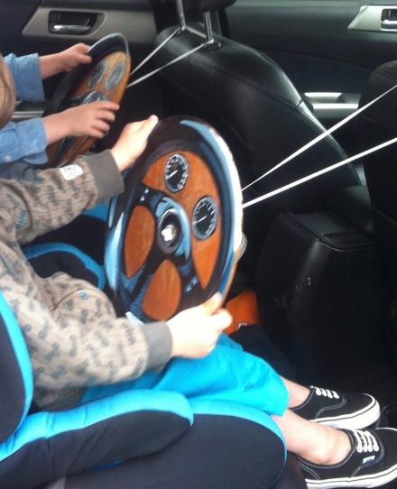 twins back seat drivers kids make car wheels